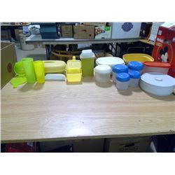 A BUNCH OF TUPPERWARE CONTAINERS AND RUBBER MADE KITCHEN SUPPLIES