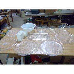 A BUNCH OF SERVING DISHES AND PLASTIC CONTAINERS
