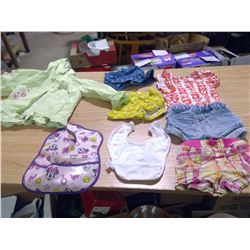 A BOX FULL OF BABY CLOTHES,BIBS,AND RAIN JACKETS