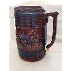 Stoneware pitcher with grapevine decoration