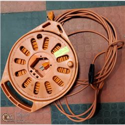 EXTENSION CORD IN ORANGE HOSE REEL CONTAINER