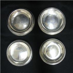 Set of four silver footed bowls; chased styl