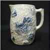 Image 1 : Molded stoneware pitcher with floral decorat