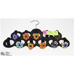 HAND BEADED RINGS ON VELVET STAND.