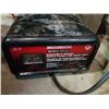 Image 2 : Tote of battery charger, extension cords and other tools