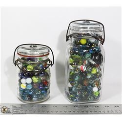 2 VINTAGE JARS FILLED WITH MARBLES.