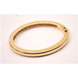 One beautifully made solid gold hinged bangle  bracelet weighing 31 gms and pave set with  4ct of G-