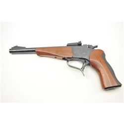 Thompson Contender Single Shot Pistol in .22 Mag caliber with a 10” round barrel, S/N 307409. Fine
