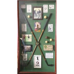 Golfing display with vintage wood clubs and old balls displayed in beautiful custom made case. Mea