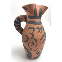 Pottery Pitcher measuring 10 ½” and painted in modernist designs and made very similar to pre-Colo