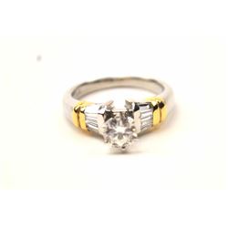 One platinum ring with 18k yellow gold accent set with a 0.60ct center and 8 baguettes approx 0.5