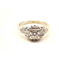 One beautifully designed vintage ring in 14k white gold set with a ¼ ct center and 18 side diamond
