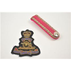 Lot of two insignias from an estate in a paper envelope. The lot includes British art patch with