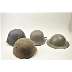 Lot of 4 foreign helmets all with liners. Varied condition from fair to very good. Est.: $100-$200
