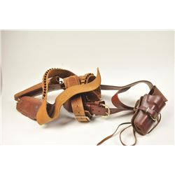 Lot of three vintage leather gun belts and single action holsters. The holsters are by various ma