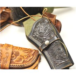 Lot of three tooled leather cartridge belts with single action holsters. The holsters are in fair