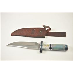 Large Chipaway Cutlery clip point Bowie knife with a tooled leather belt scabbard. The knife is 1