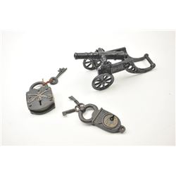Lot of two vintage padlocks and a cast iron cannon with carriage. One padlock has crossed cavalry