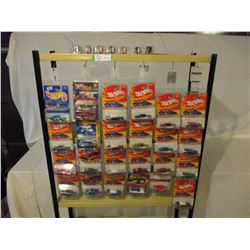 31 N.I.P Assorted Chevrolet Hot Wheels and John Lightning Cars with Metal Display Shelf 10" by 70"T