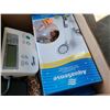 Image 2 : Box of blood pressure monitor, thermassager, shower head and hot water bottle