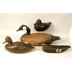 A GROUP OF FOUR WOODEN DECOYS
