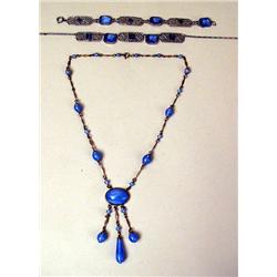 A BLUE CRYSTAL AND SILVER TONE FILIGREE