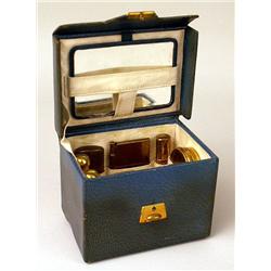A DIMINUTIVE LEATHER HANDLED TRAVEL CAS