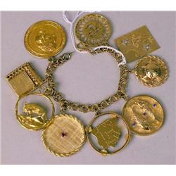 A 14K YELLOW GOLD CHARM BRACELET