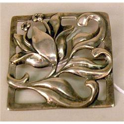 A STERLING SILVER SQUARE STYLIZED FLORA