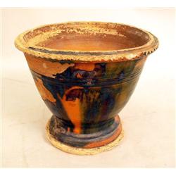 A GLAZED REDWARE FLOWER POT WIH CRIMPED