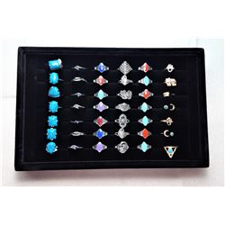 25)  LOT OF 42  RINGS IN DISPLAY CASE