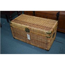 Wicker hinged lidded trunk with glass top, used as coffee table