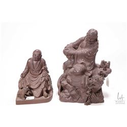 Two Oriental fired clay figures including 9" figure with dragon guardian and 6 1/2" Buddha type