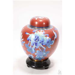 Oriental Cloisonne lidded ginger jar with cinnabar coloured background blue flowers, 9 1/2" in heigh