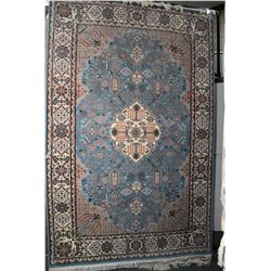 Large wool blend area carpet with center medallion, floral and foliage design in shades of blue, tau