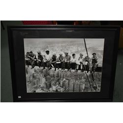 Framed black and white photographic print of ironworkers on their lunch break