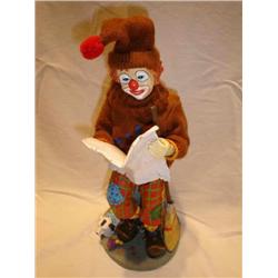 Clown reading paper Figurine