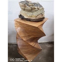CALCITE GEODE ON A LAMINATED SPIRAL WOOD STAND.