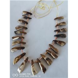 20 BUFFALO TEETH STRUNG TOGETHER WITH RAWHIDE,