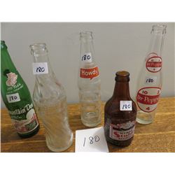 5 bottles - wishing well, mountain dew, howdy, Dr. Pepper etc.