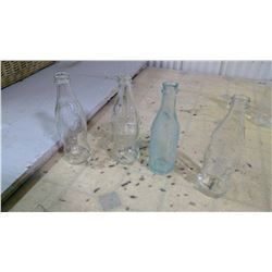 4 CLEAR COKE BOTTLES TALLER ONE BLUISH IS SLIGHTLY CRACKED CHIPPED