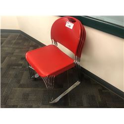 STACK OF RED STACKING STUDENT CHAIRS