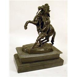 A BRONZE SCULPTURE OF A MAN AND A HORSE