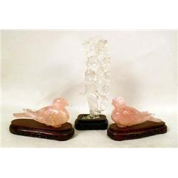 A PAIR OF ROSE QUARTZ BIRDS RESTING ON 