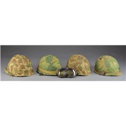 4 US M1 HELMETS W/ CAMOUFLAGE COVERS.