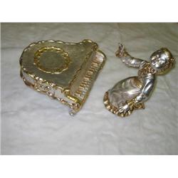 Figurine of girl playing piano