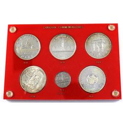 1935-1964 Canadian commemorative coins in Vintage holder. Coin includes 1935 silver Dollar, 1939 Sil