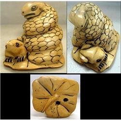Netsuke of carved bone a snake and a fr