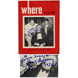 Jack Dempsey Signs His Photo on a Travel Magazine Cover