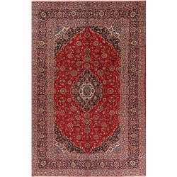 A WOOL HAND KNOTTED FLORAL ORIENTAL AREA RUG.